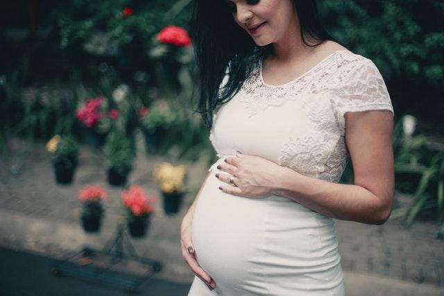 Pregnant woman holding tummy