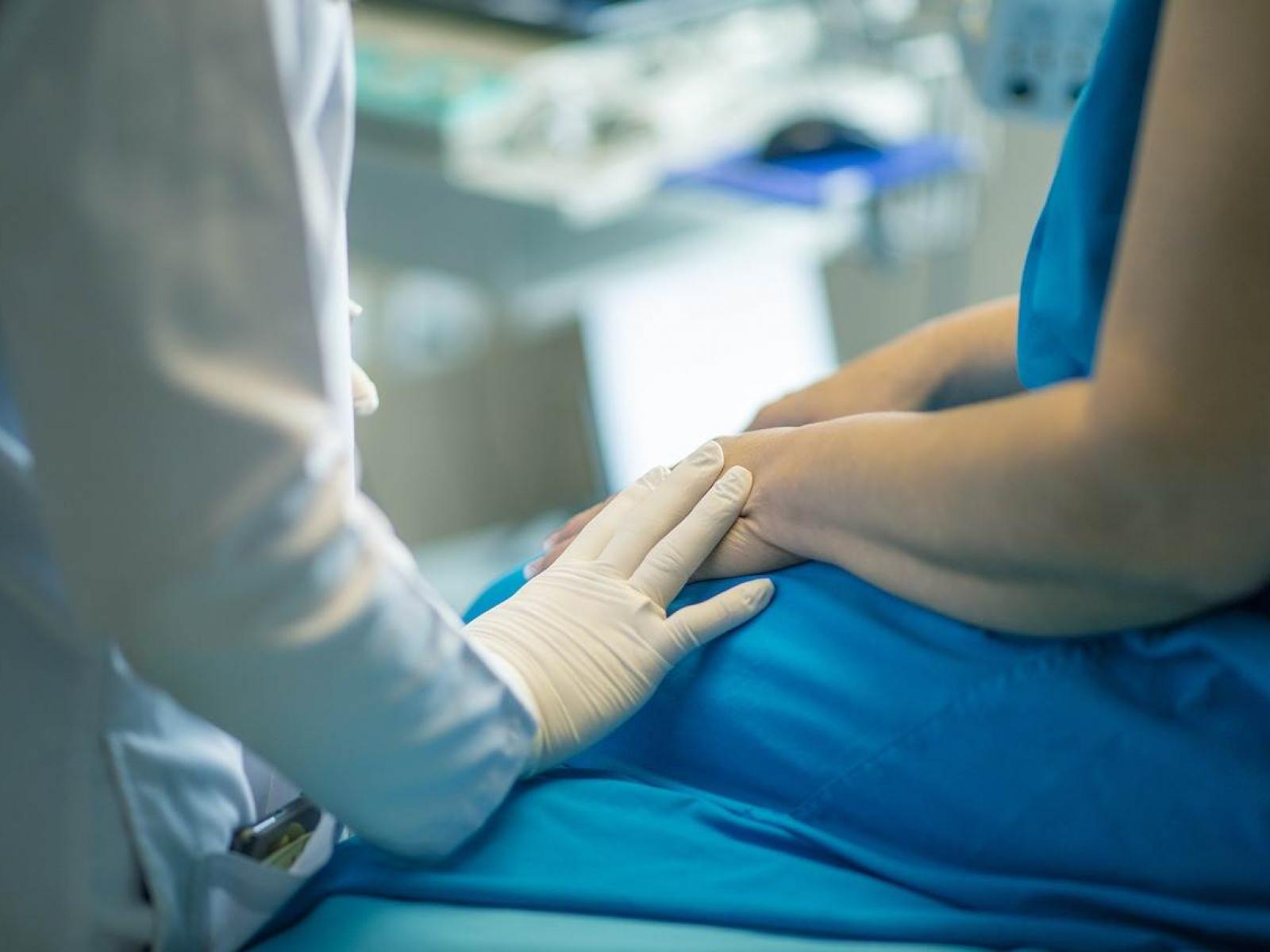 A nurse cares for a patient